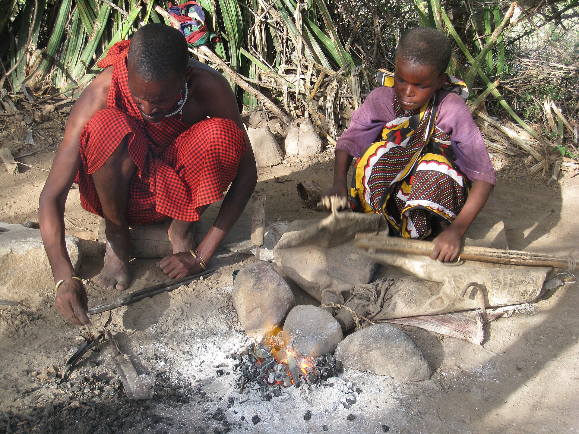 A Datoga blacksmith forging tools by hand